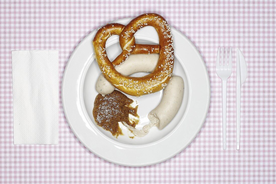 A pair of Weisswurst (white sausages), mustard & pretzel on plate