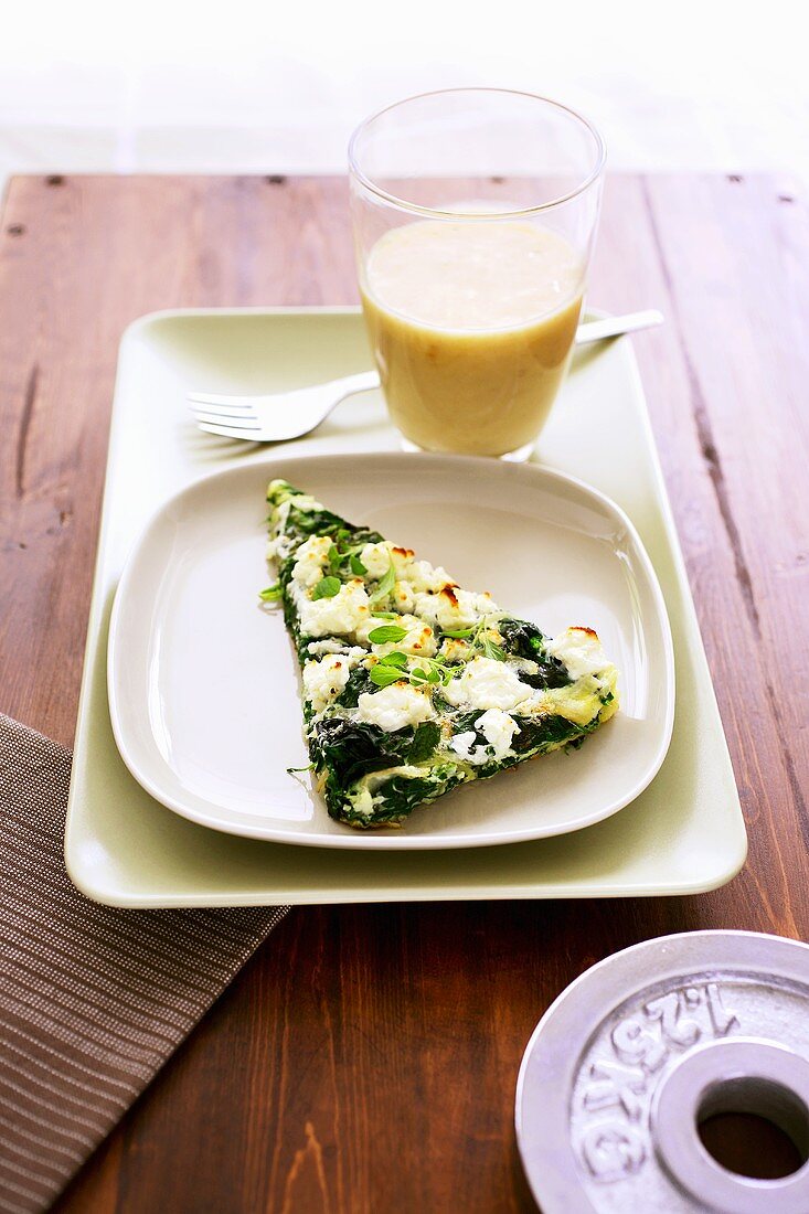 A piece of spinach and feta frittata with banana milkshake