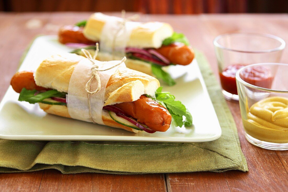 Baguettes filled with sausages, rocket and salad