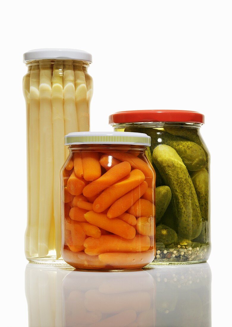 Carrots, asparagus and gherkins in jars