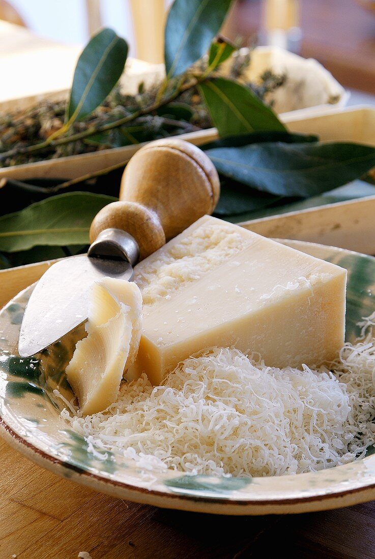 Parmesan, a piece & grated, in a deep plate with cheese knife