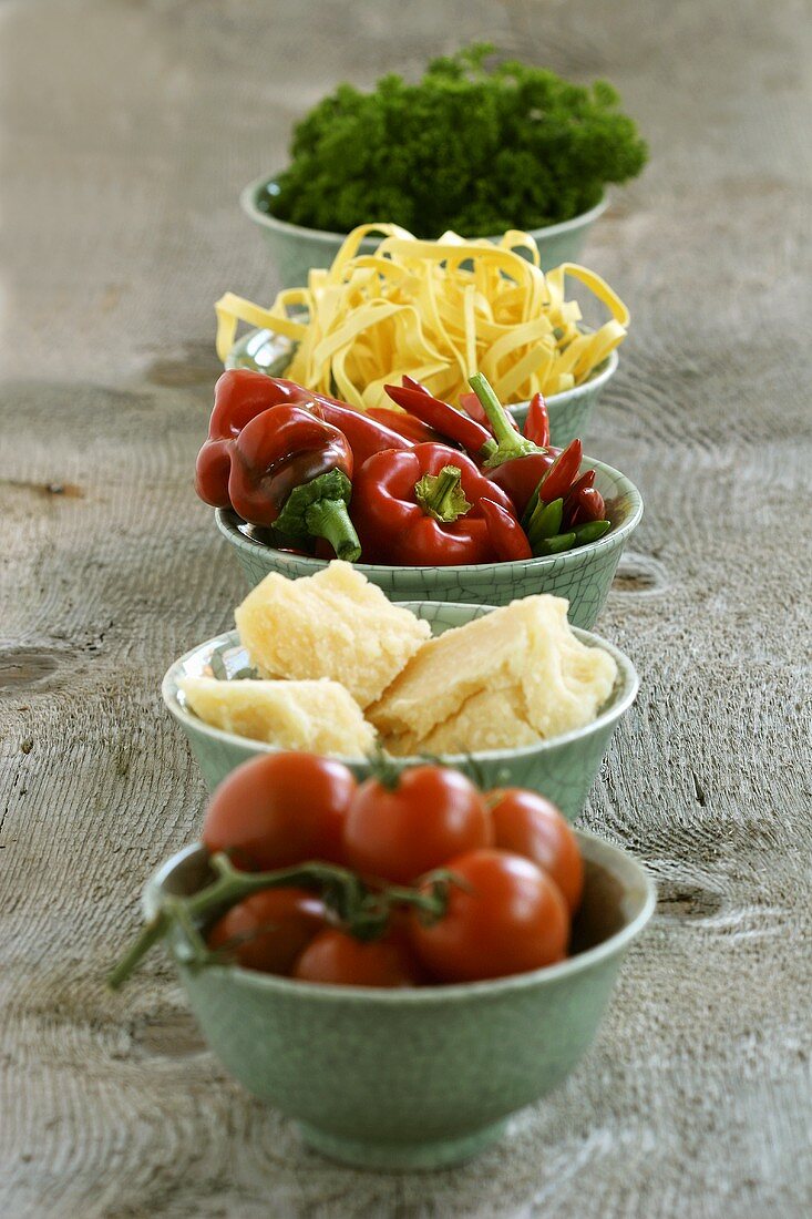 Various pasta ingredients in small bowls