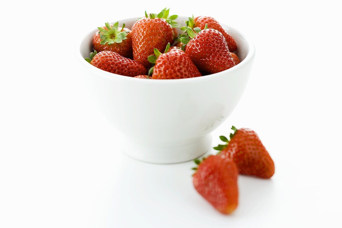 Fresh strawberries in small white bowl