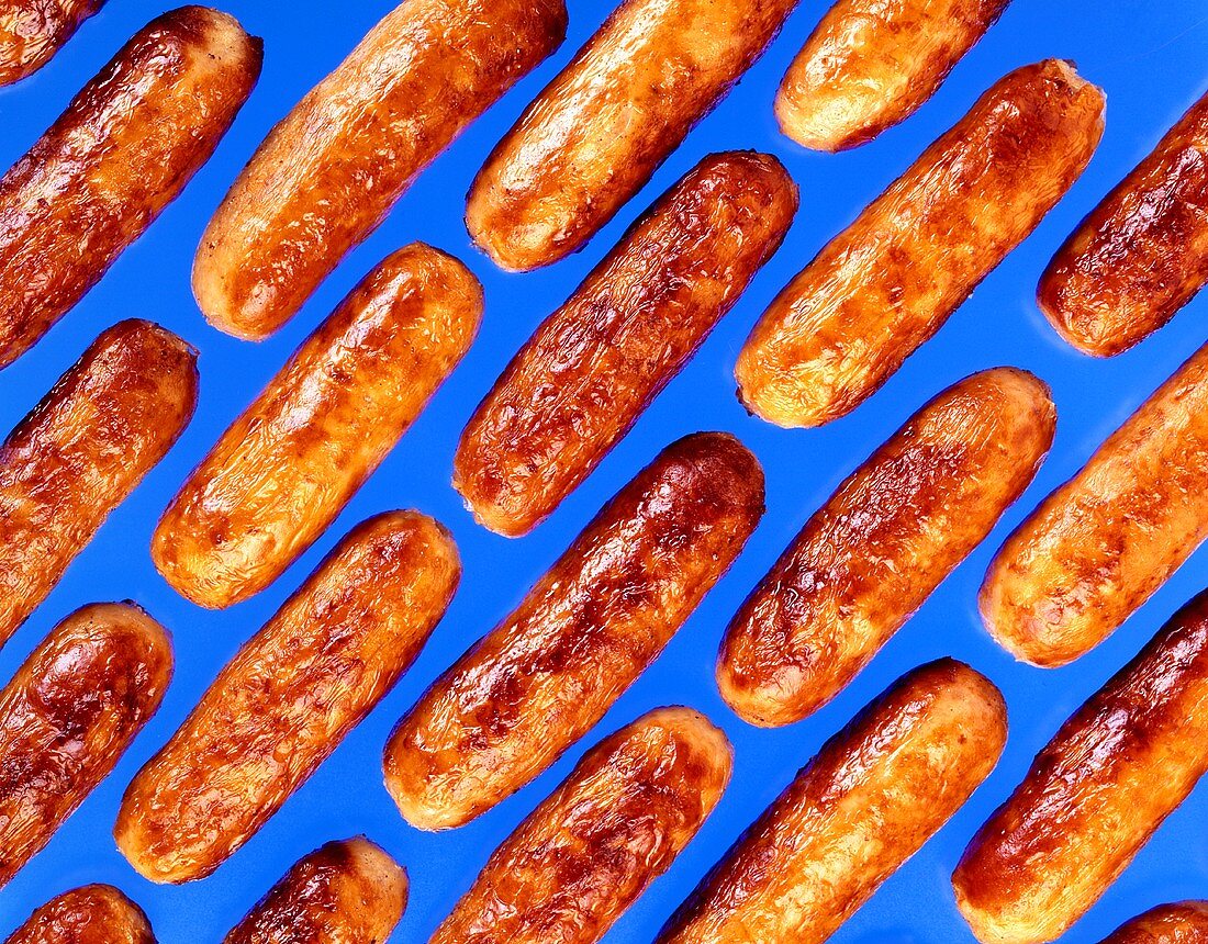 Fried sausages on blue background