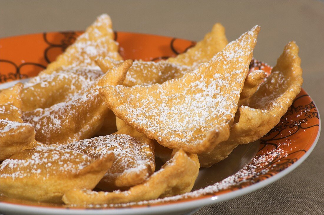 Fried pastries with icing sugar