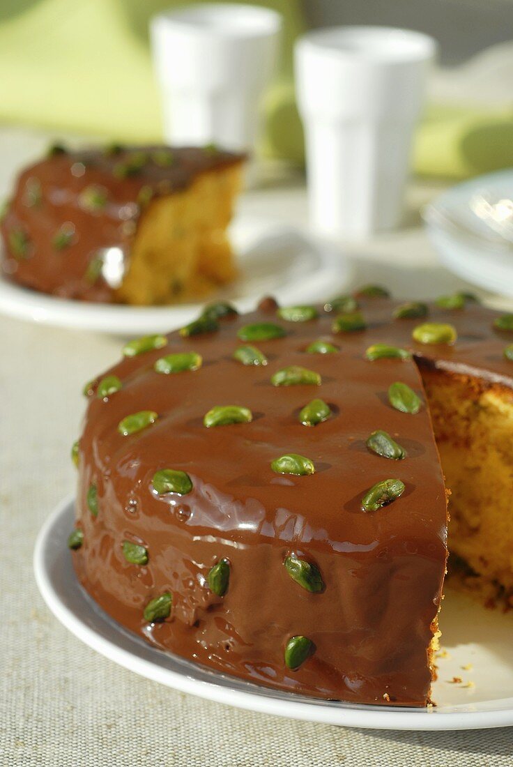 Pineapple cake with chocolate icing and pistachios