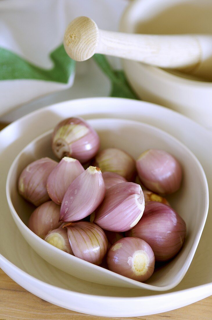 Peeled shallots in a small bowl