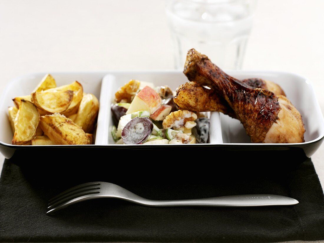 Chicken legs with potato wedges and apple salad