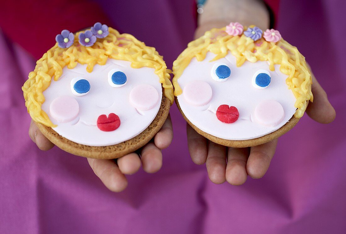 Two Amerikaner cookies with faces