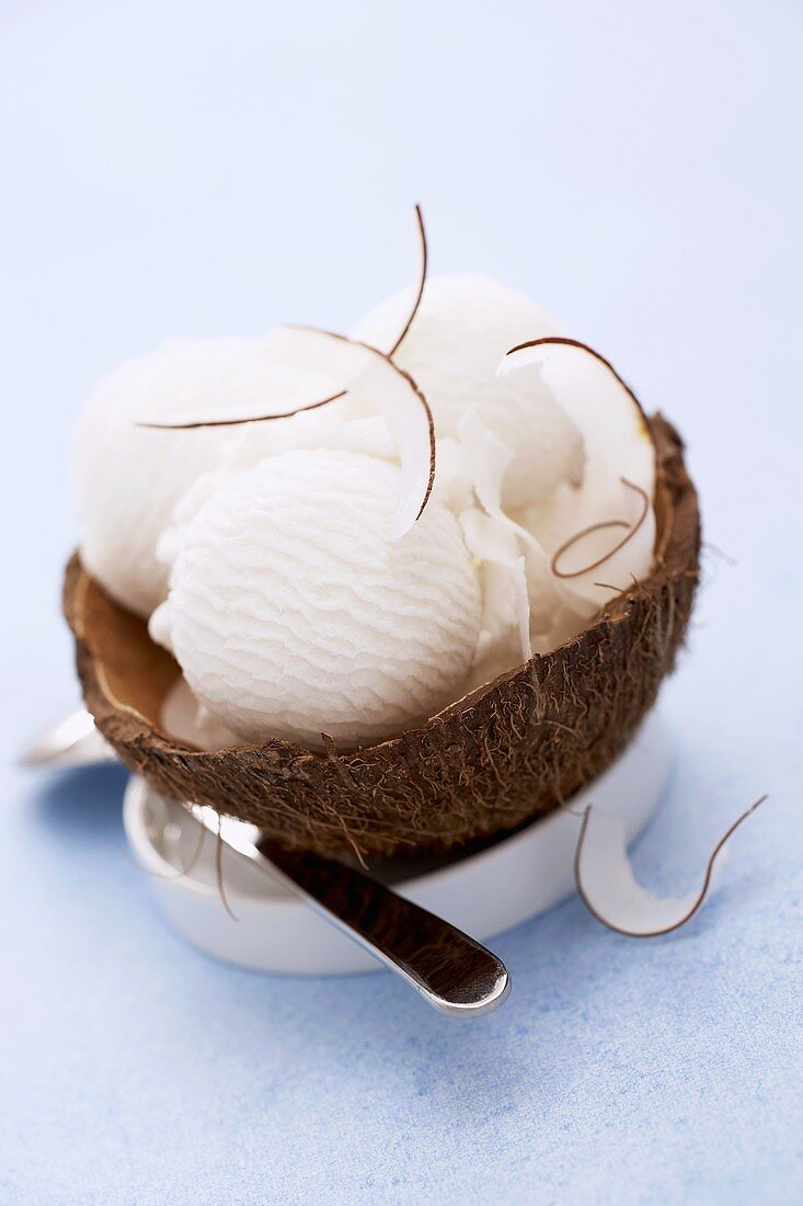 Three scoops of coconut ice cream in a coconut