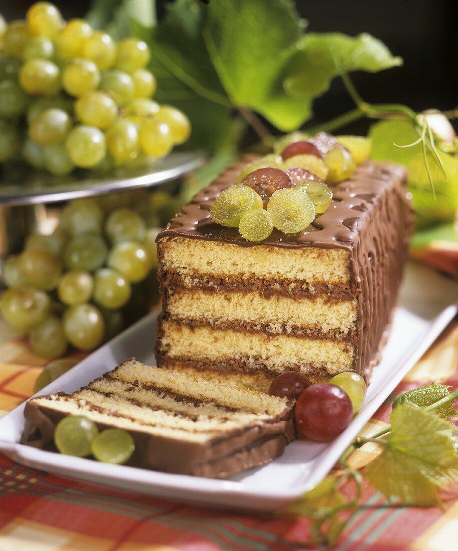 Sponge slice with chocolate cream and sugared grapes