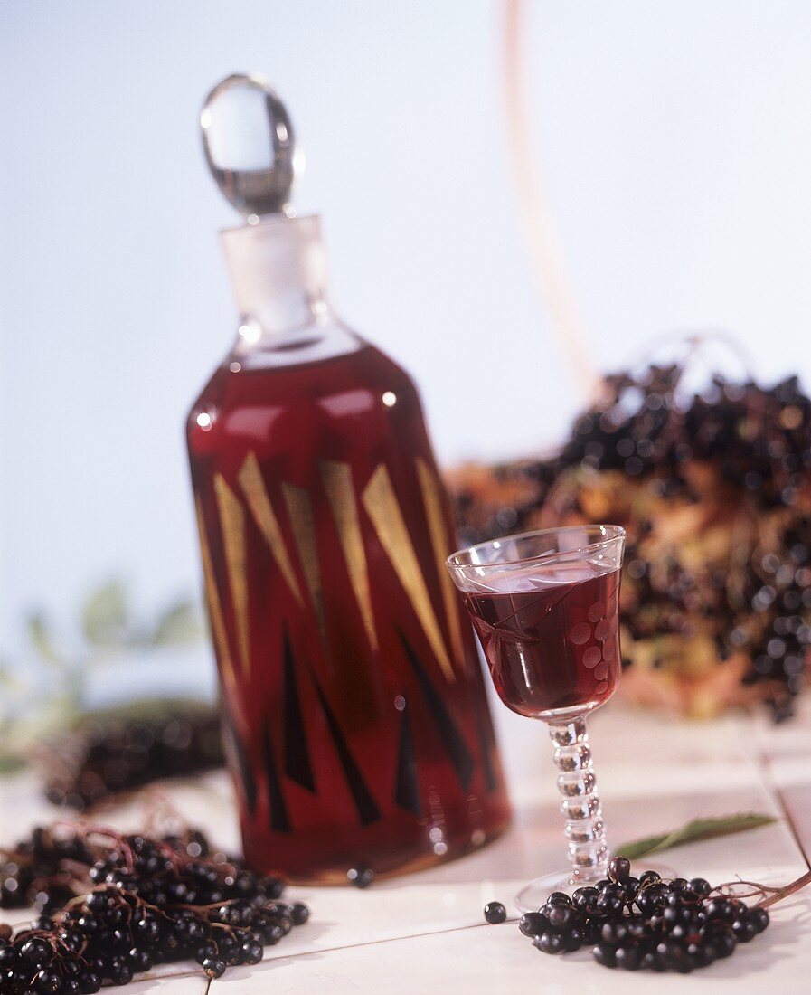 Elderberry liqueur in bottle and glass