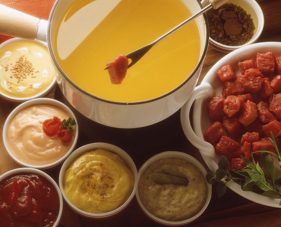 Meat fondue with various dips