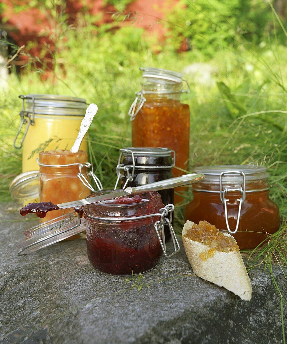 An assortment of jams in preserving jars