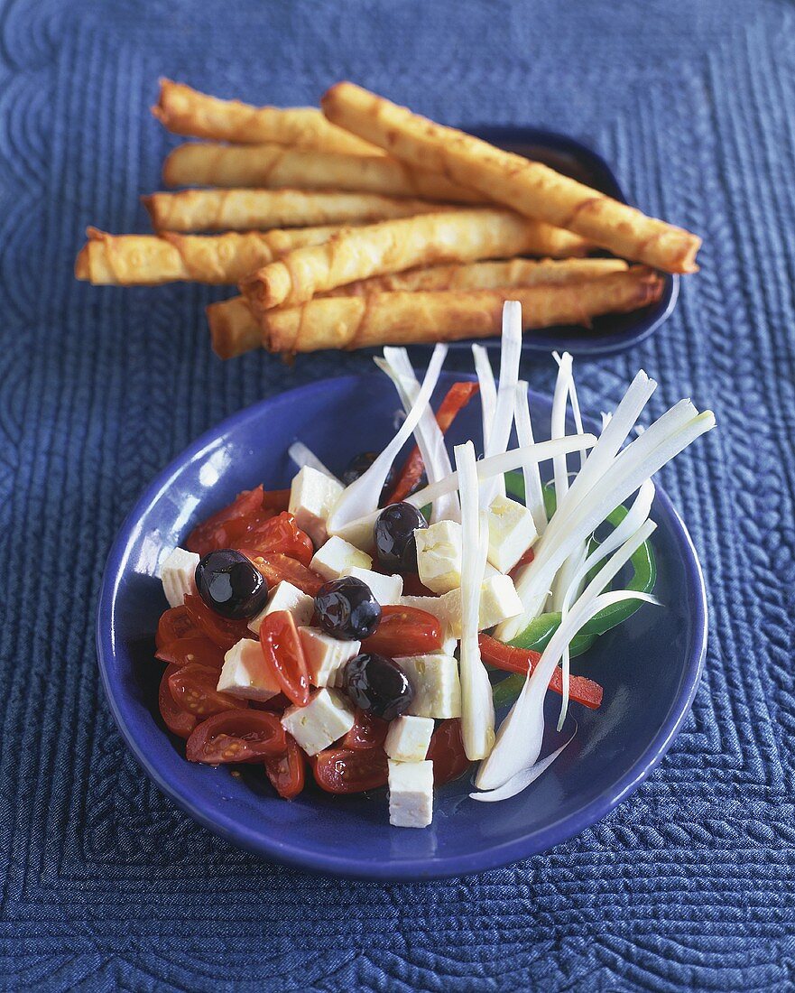 Goat's cheese and tomato salad with savoury sticks
