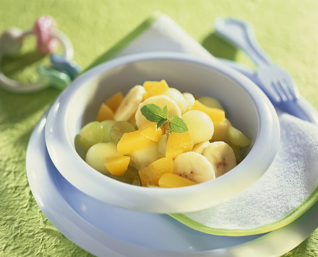 Fruit salad: melon, grapes, banana and peach