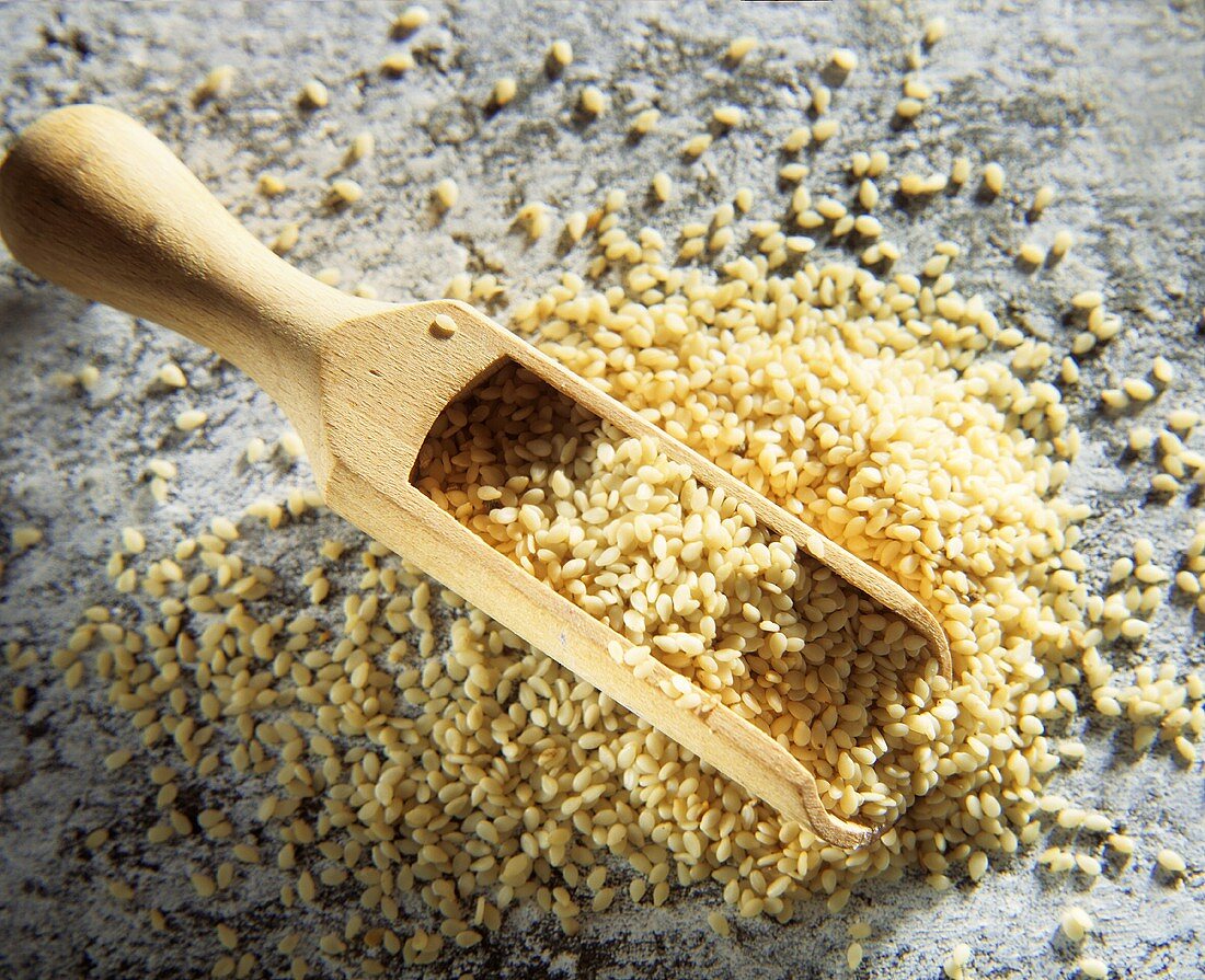 Sesame seeds with wooden scoop