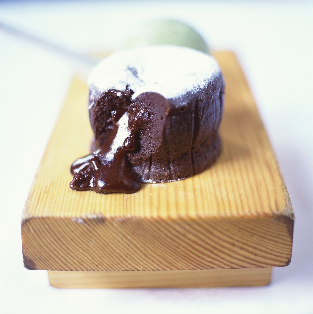 Chocolate pudding with icing sugar and chocolate sauce