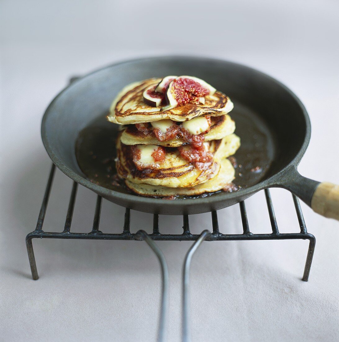 Pancakes with figs in frying pan