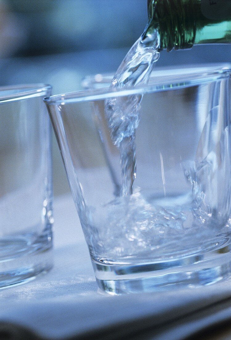 Pouring mineral water into a glass