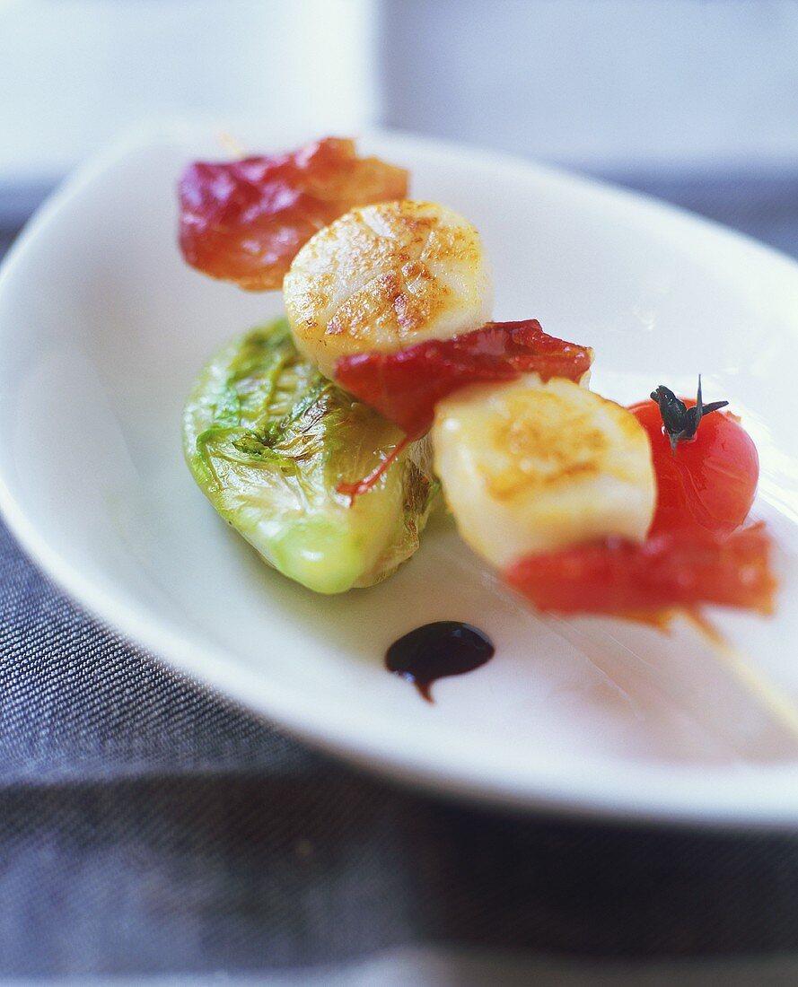 Scallop and ham skewer with roasted vegetables