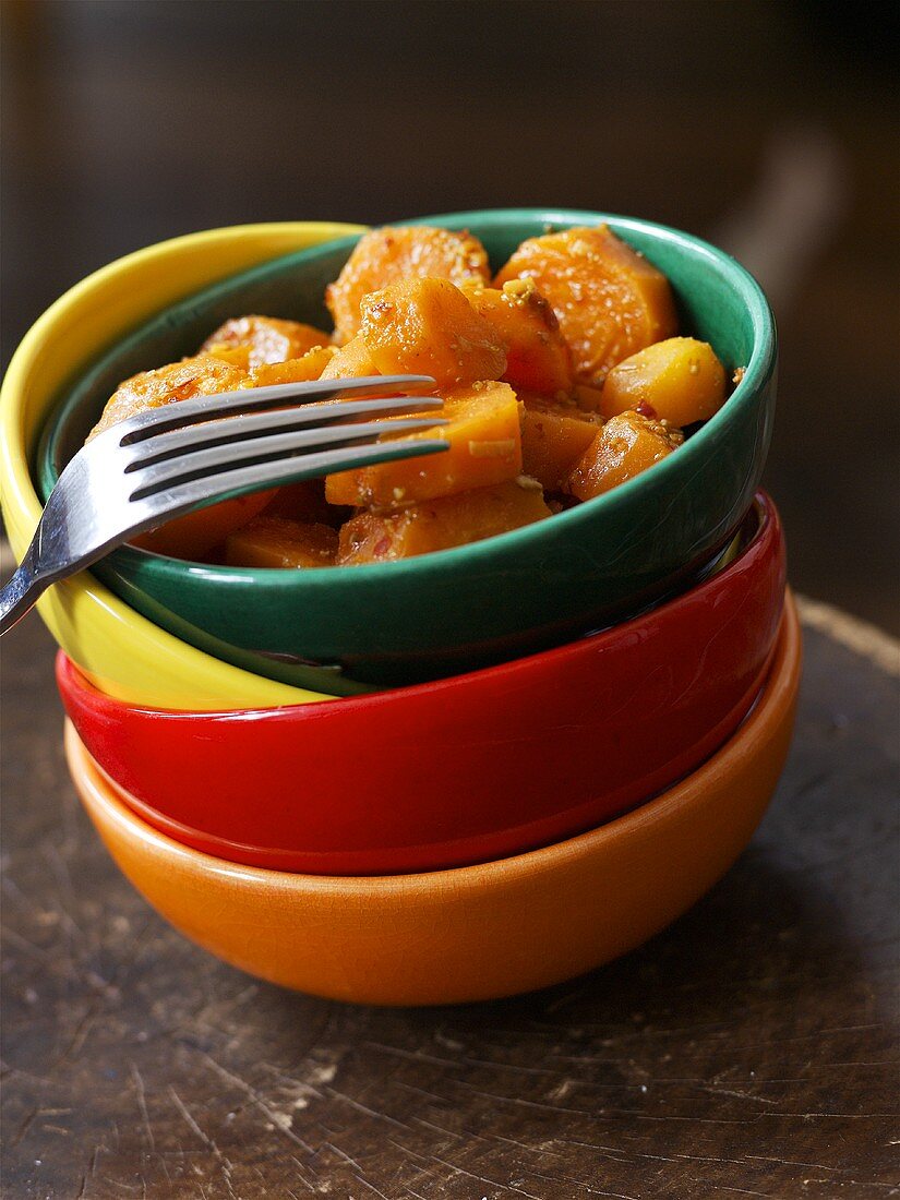 Carrot salad in a pile of bowls