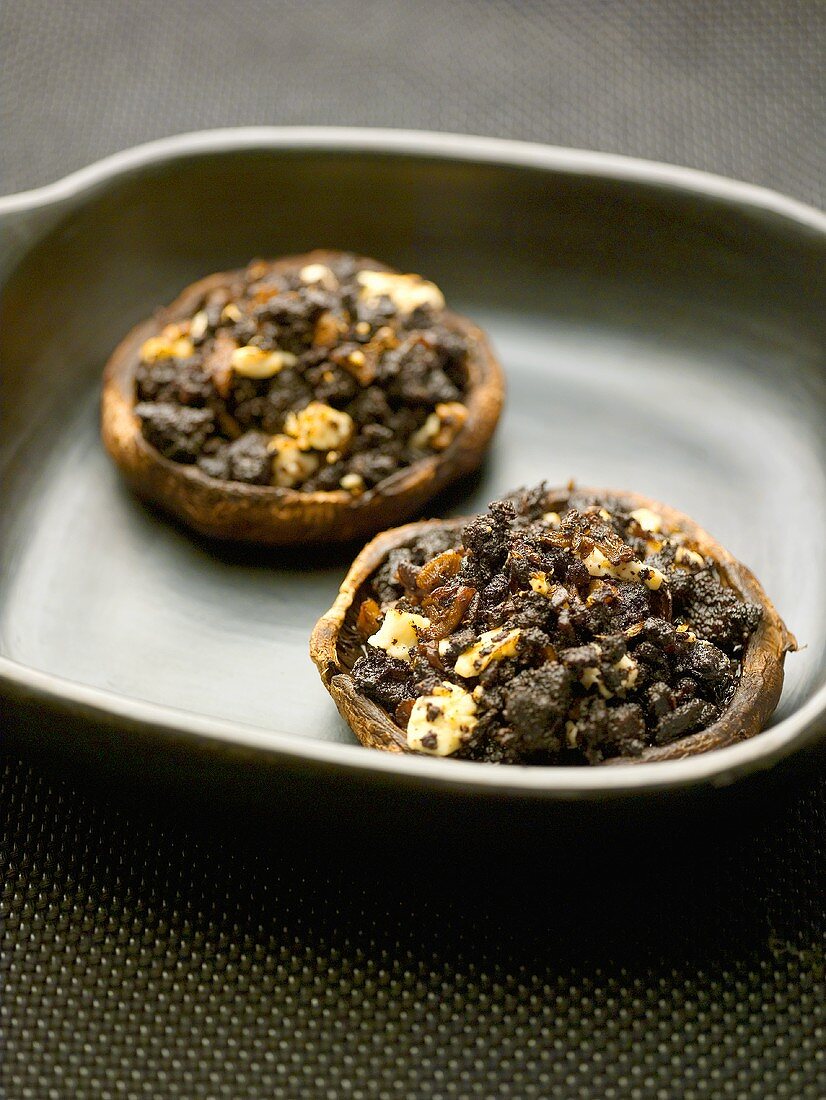 Two mushrooms stuffed with black pudding