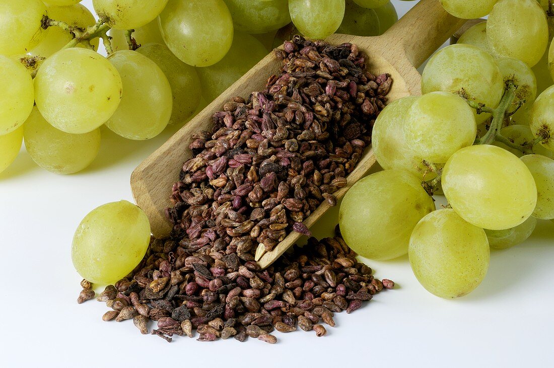 Grapes and grape seeds in a wooden scoop