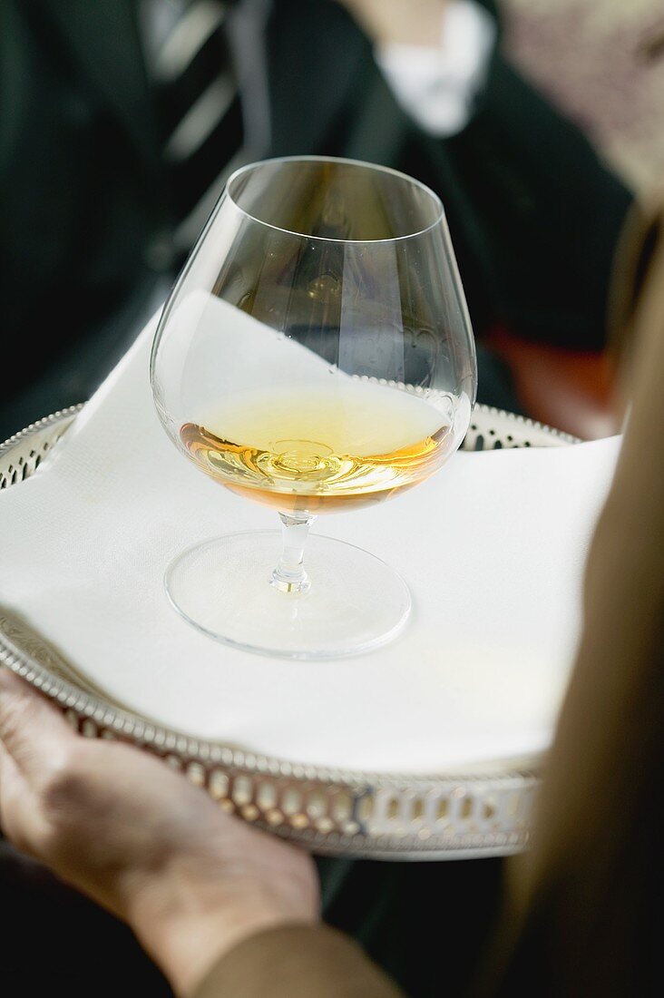 Cognac being served in a snifter