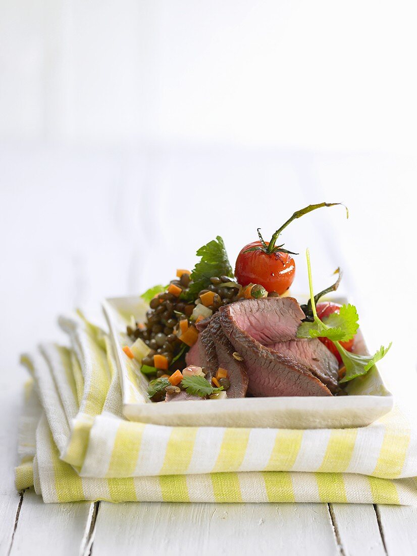 Lamb fillet with spicy lentil salad