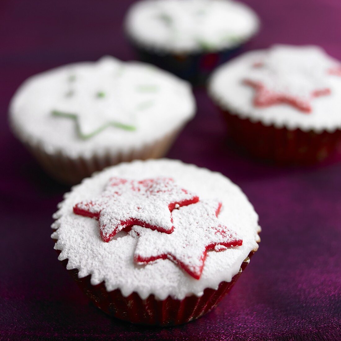 Christmas cupcakes with marzipan stars and icing sugar
