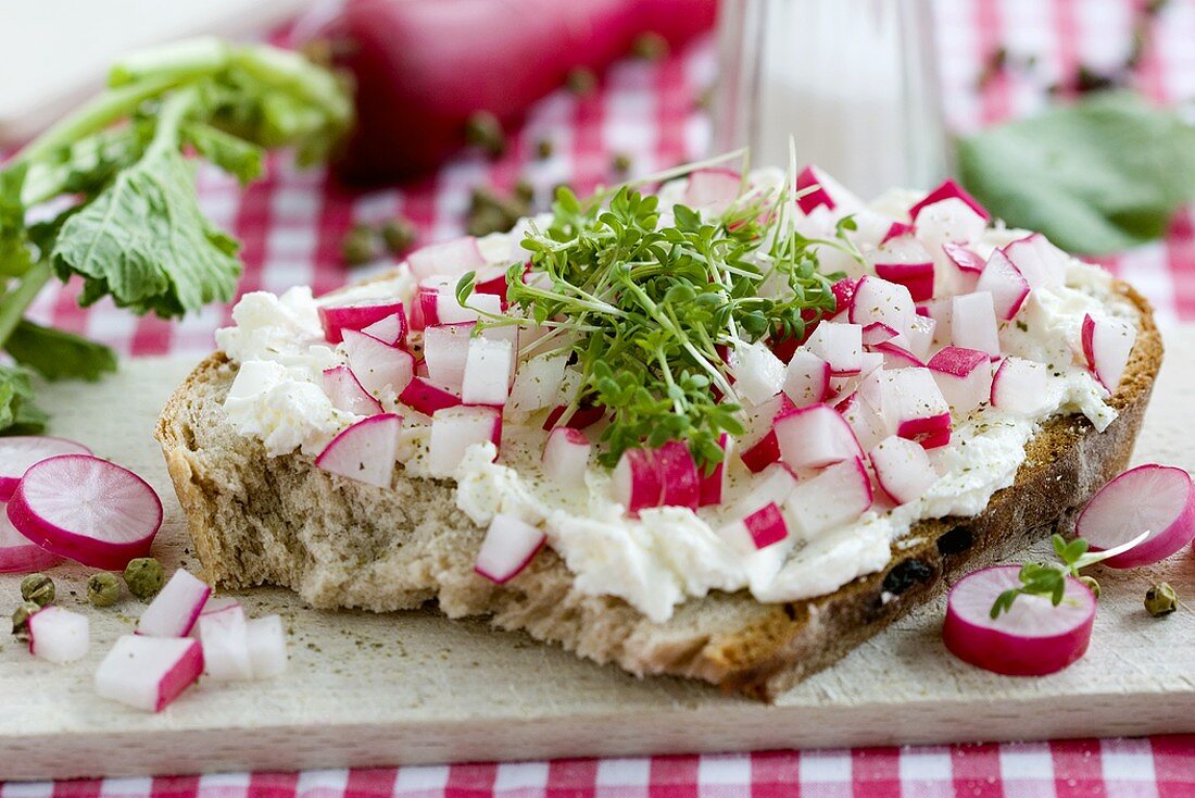Farmhouse bread topped with soft cheese, radishes, cress & pepper