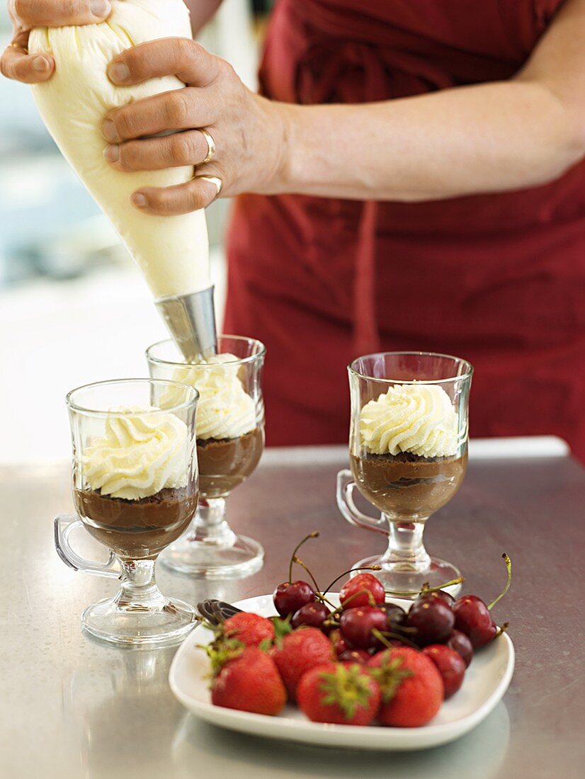 Decorating chocolate cream with cream topping