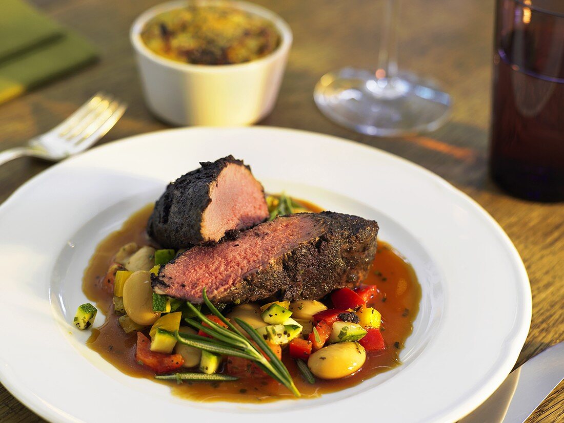 Lamb fillet with bean salad and potato & courgette gratin