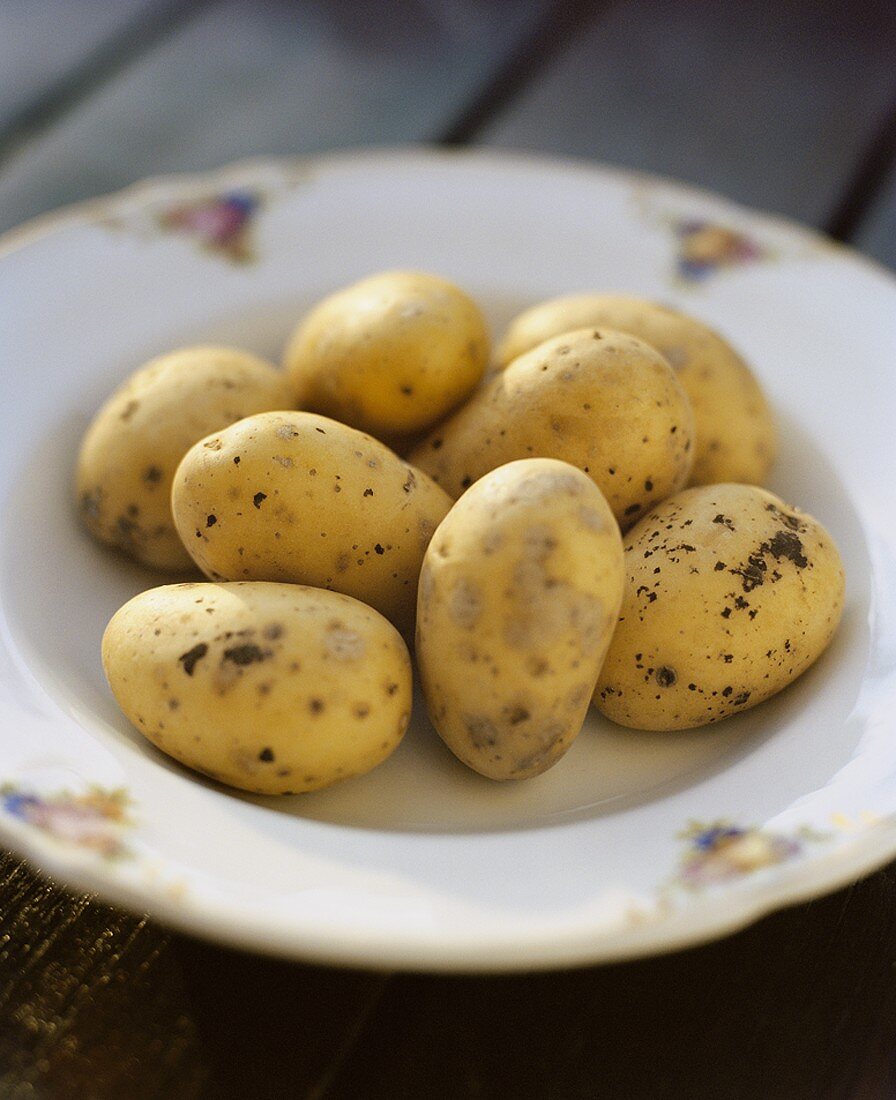 Fresh potatoes in deep plate