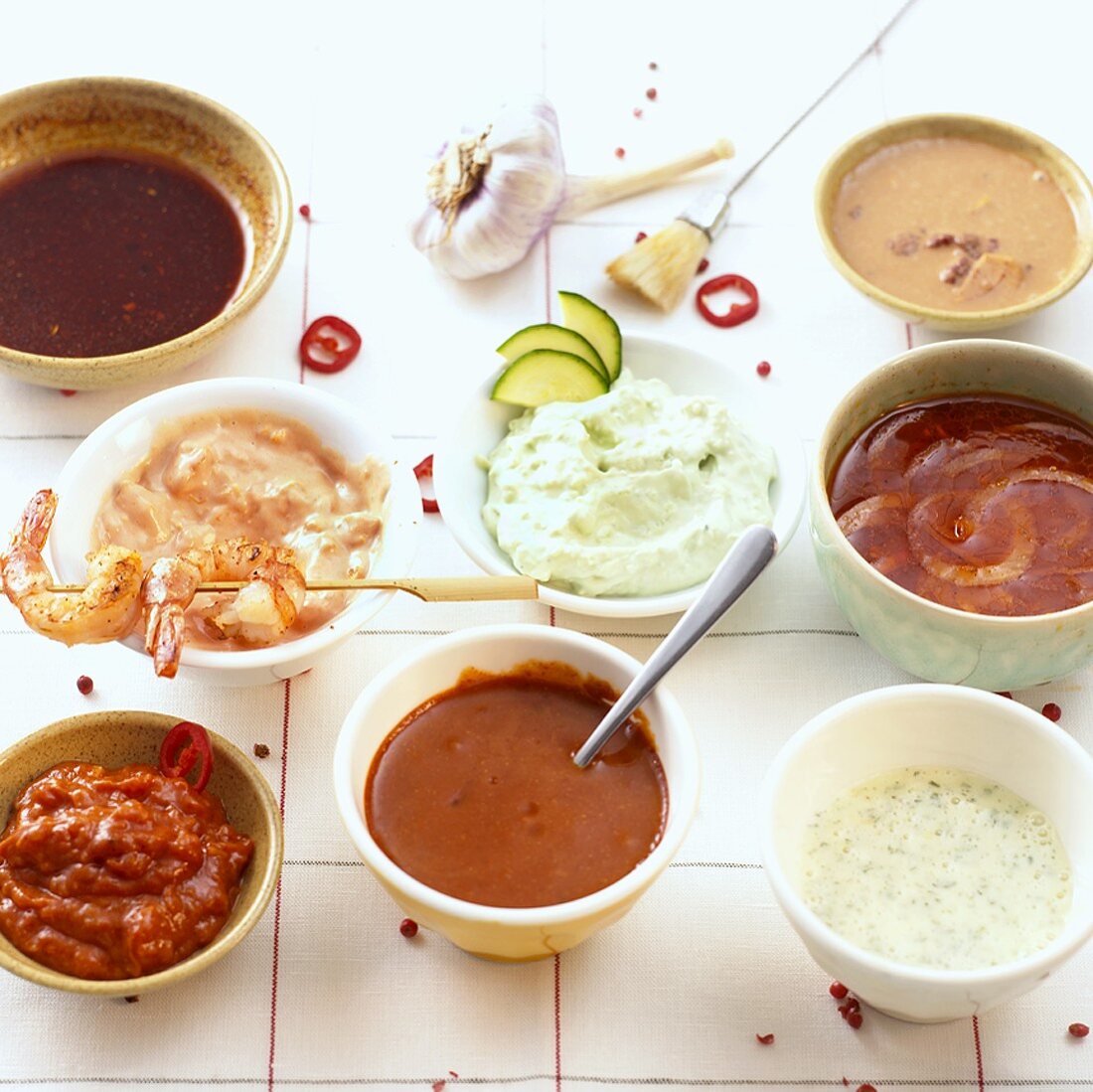 An assortment of spicy dips in small bowls