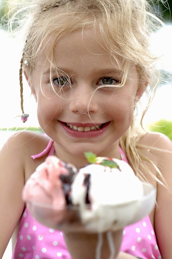 Blond girl with a mixed ice cream sundae