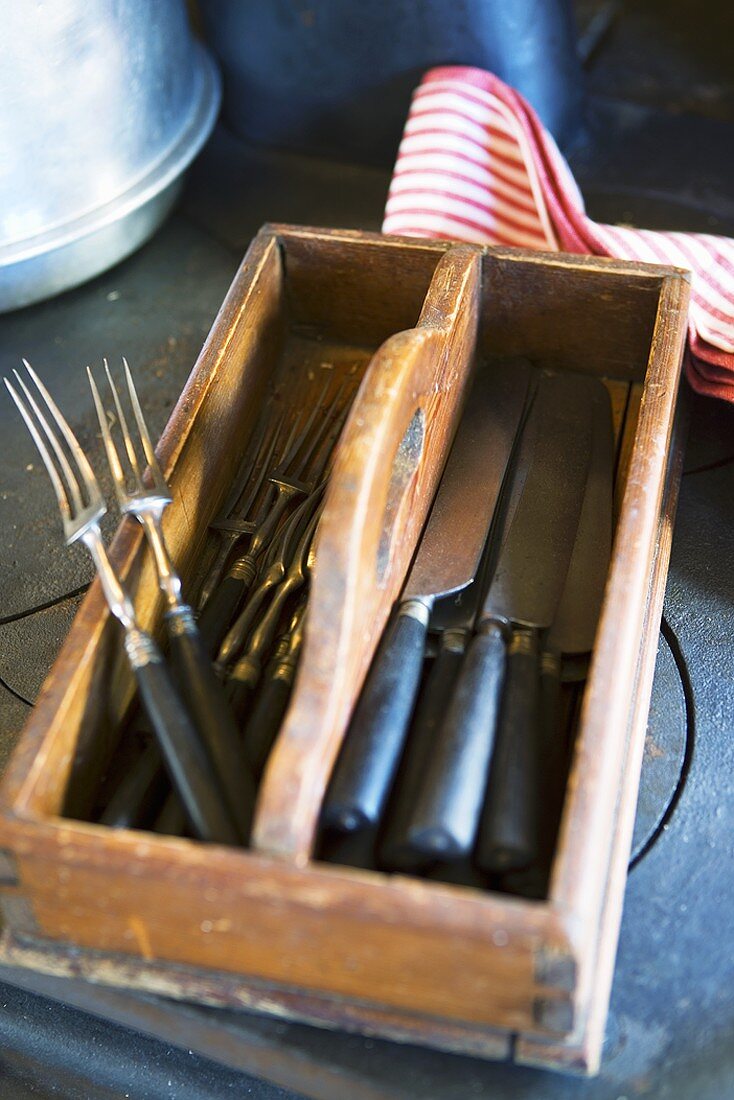 Knives and forks in wooden cutlery box