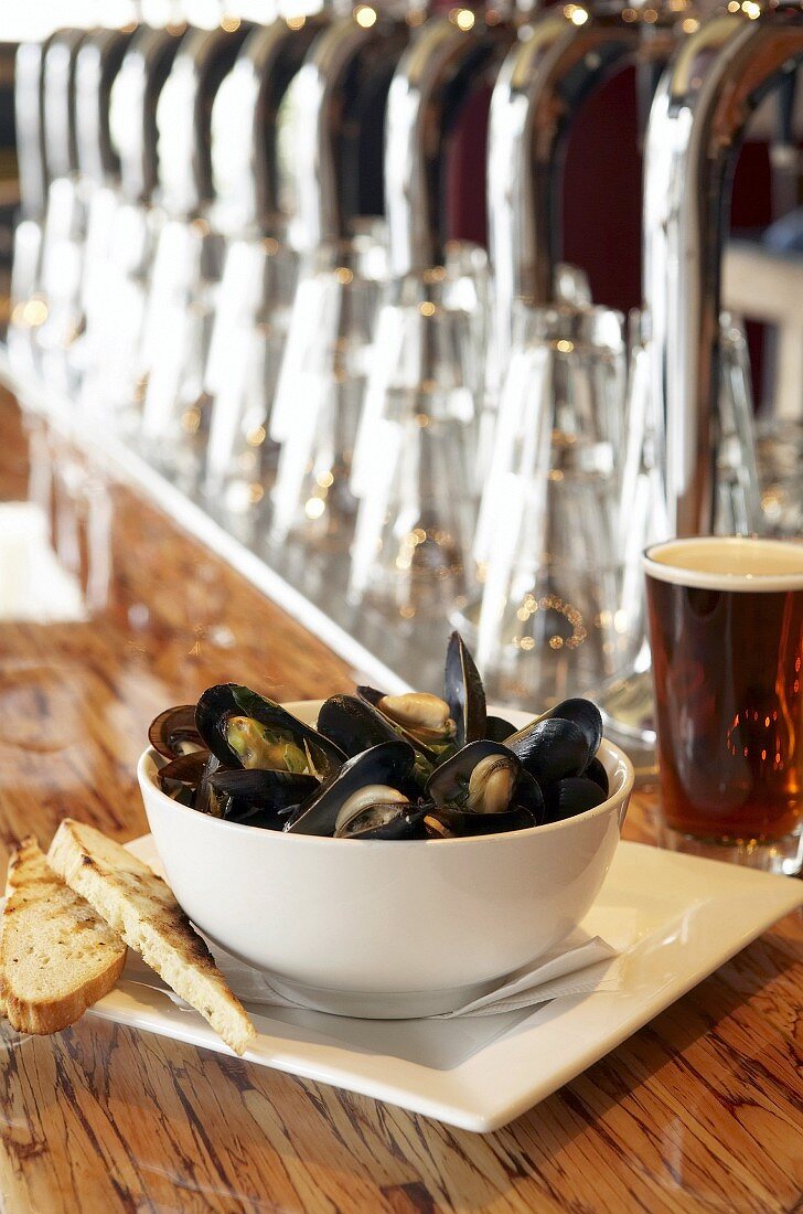 Bowl of mussels, bread and beer