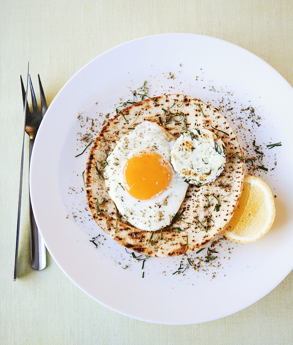 Flatbread topped with fried egg and baked goat's cheese