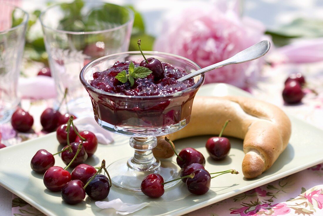 Cherry jam in a small glass pedestal bowl