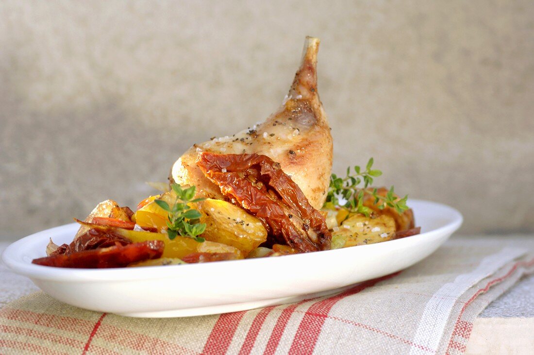 Braised rabbit leg with roast potatoes and vegetables