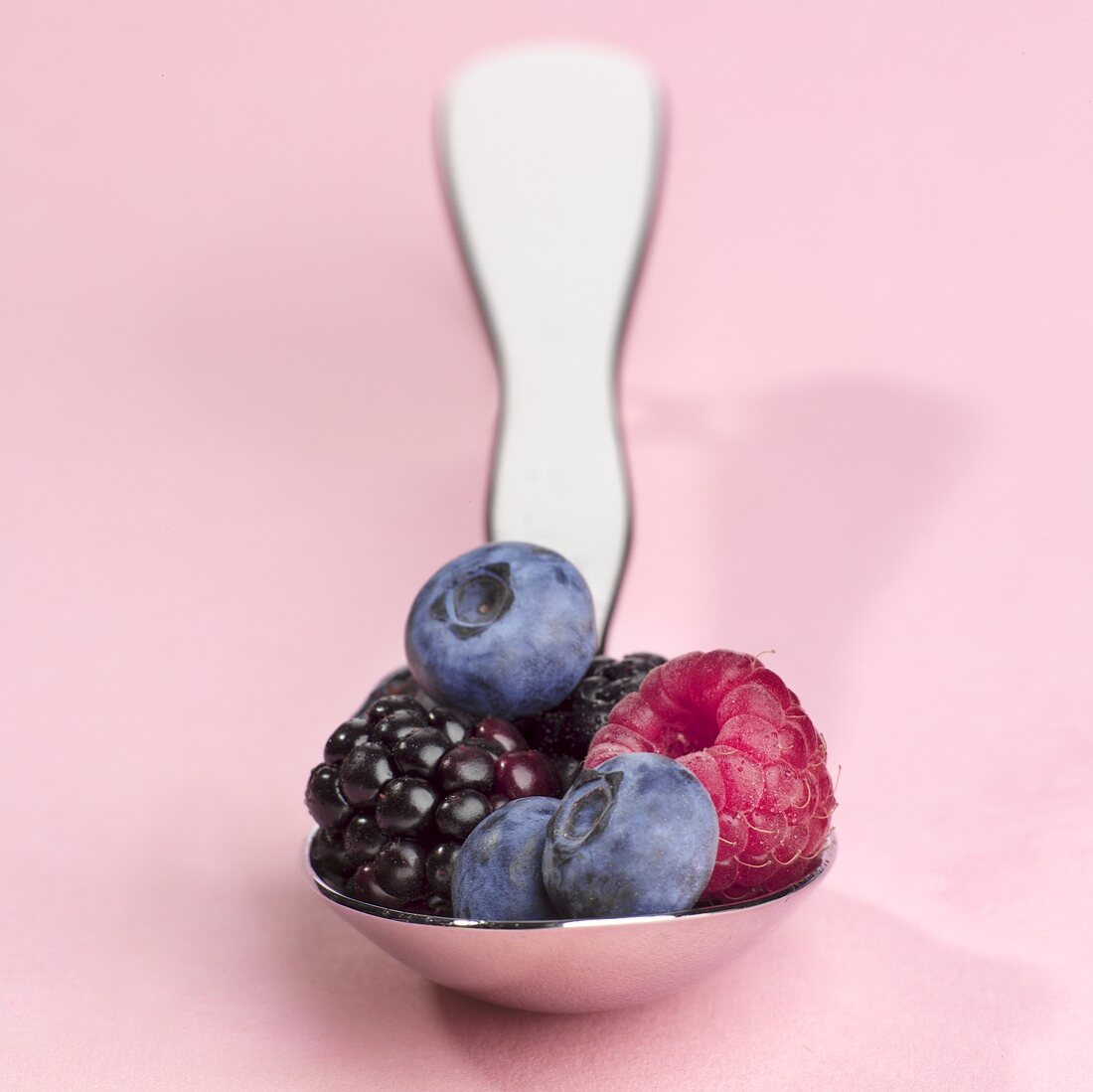 Various berries on a spoon
