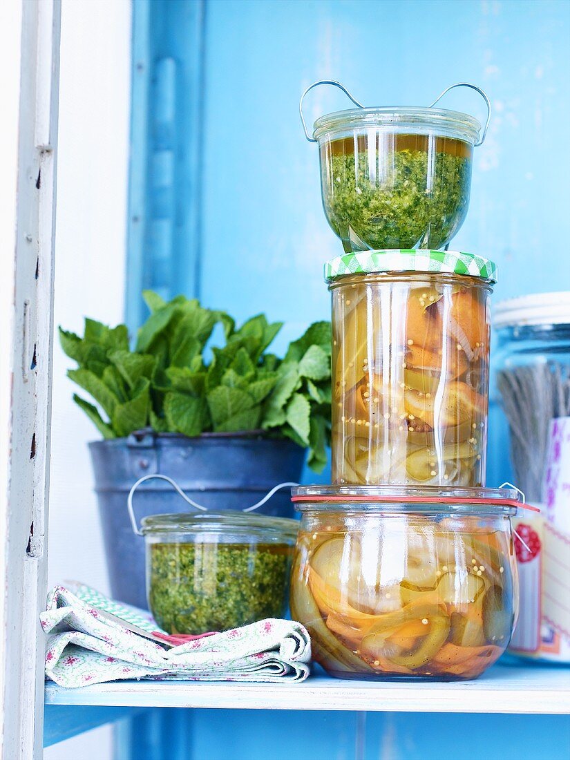 Mint and cashew pesto and pickled vegetables in preserving jars