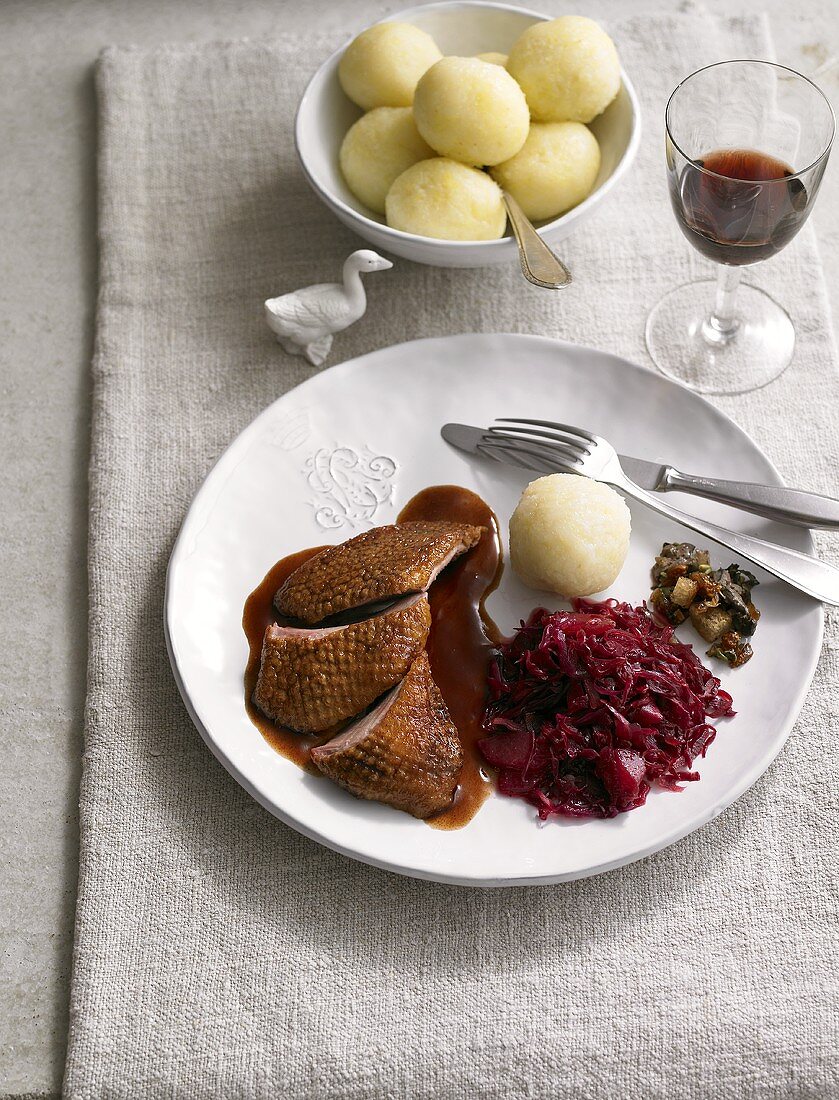 Roast goose with port wine sauce, red cabbage and potato dumplings
