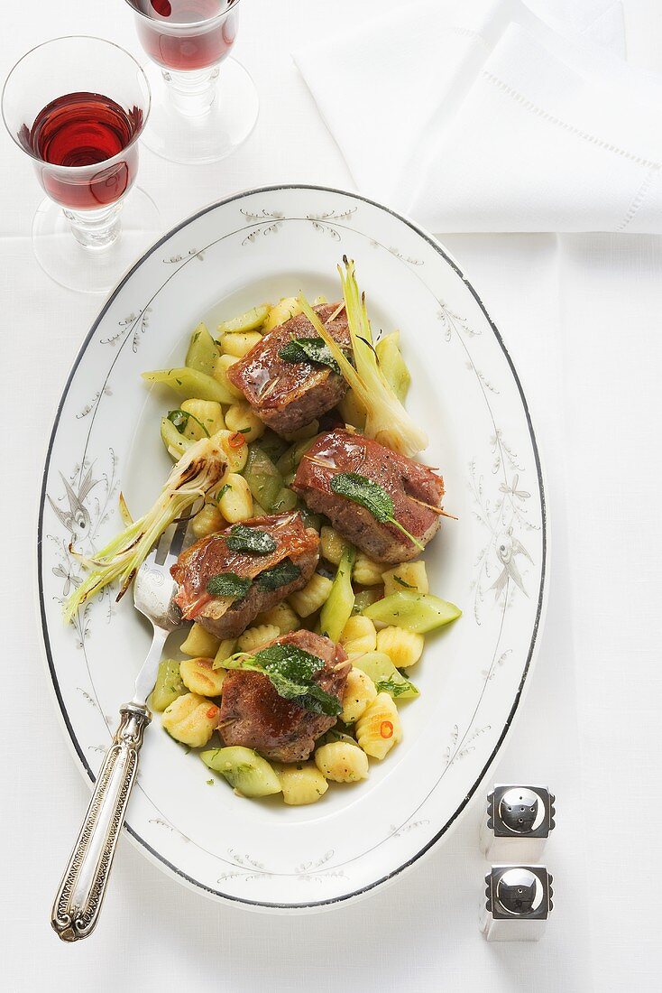 Pork saltimbocca with gnocchi and gherkins