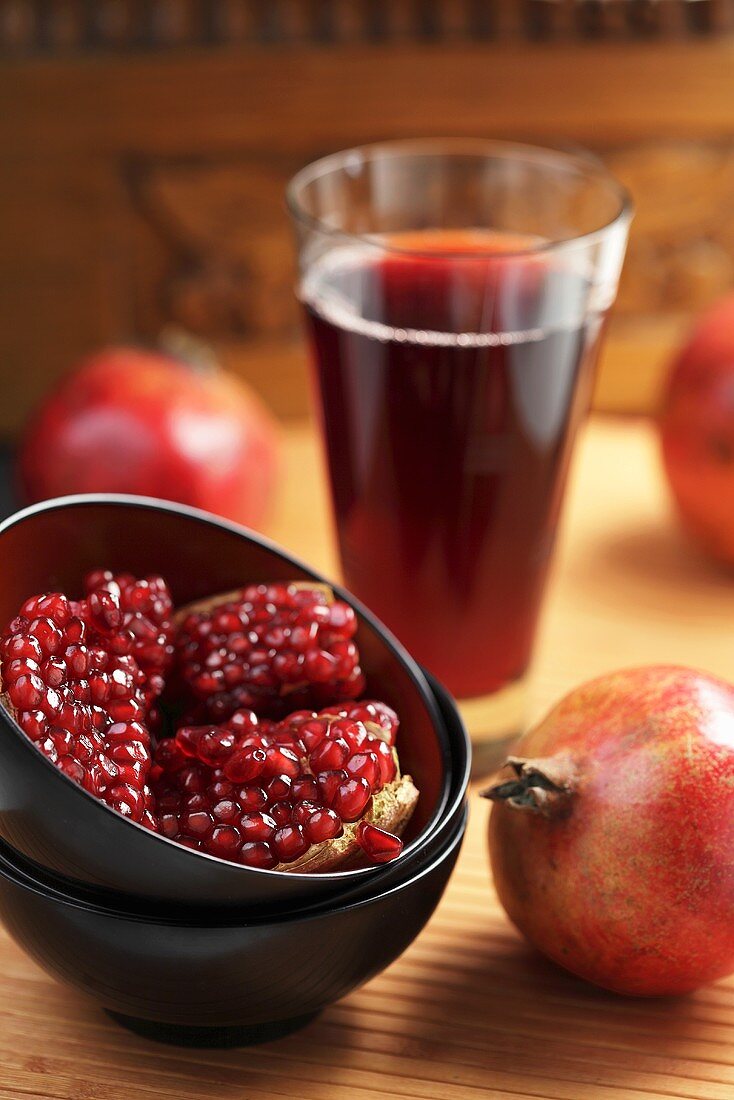 A pomegranate, pomegranate seeds and pomegranate juice