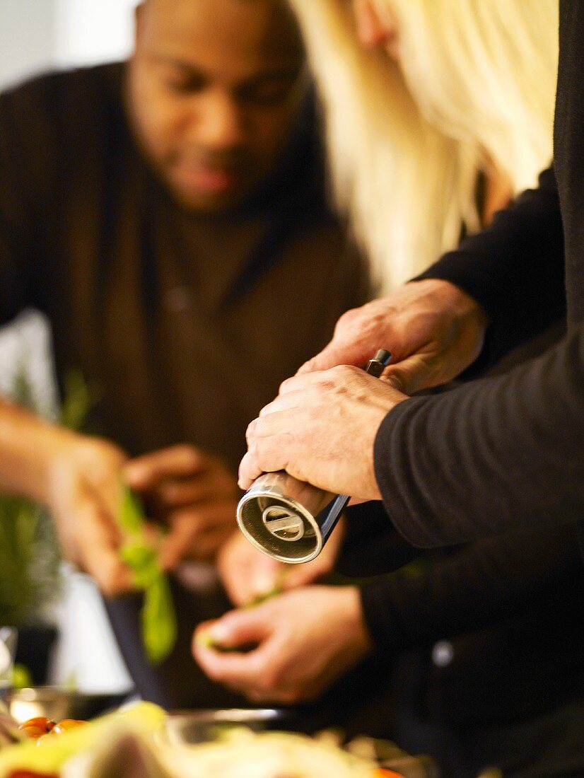 Three people preparing food