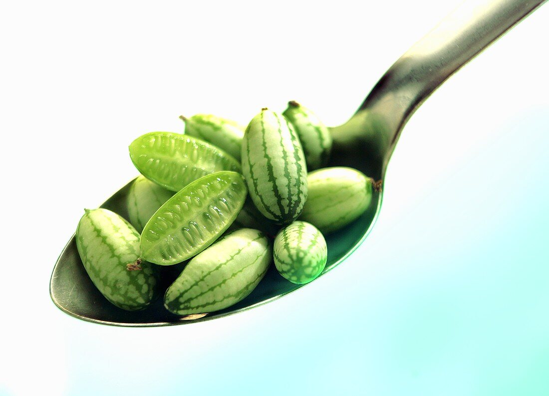 Baby cucumbers on a tablespoon