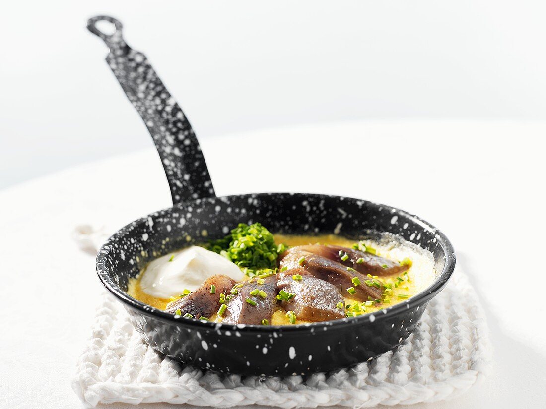 Matjes herring omelette in a small frying pan